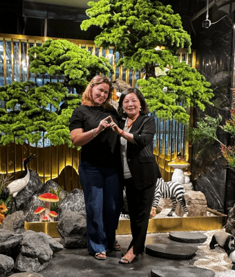 Couple posing with artificial tree